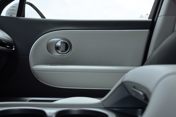 The IONIQ 9 second-row door panel, showing the trim and speaker grille